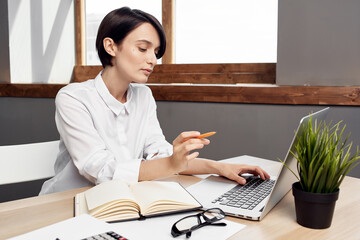 Business woman sitting at her desk in front of laptop secretary Professional