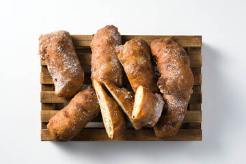 homemade bread over wooden cutting board. top view white background