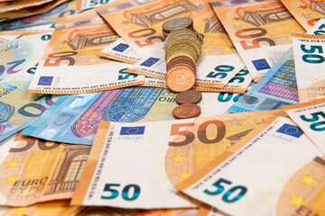 coins on the background of euro banknotes, Euro bill as part of the economic and trading system