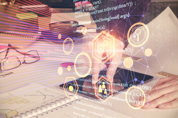 Double exposure of man's hand holding and using a digital device and data theme drawing. Technology concept.