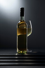Fototapeta na wymiar Bottle and glass of white wine.