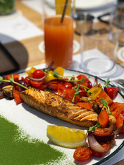 Roasted salmon steak with vegetables garnish