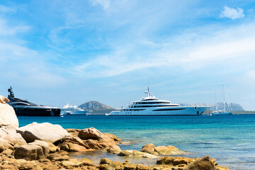 Stunning view of some luxury yachts sailing on a turquoise water during a sunny day. Cala di volpe...