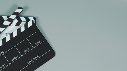 Fototapeta na wymiar Black and white Clapperboard or clapper board or movie slate use in video production ,film, cinema industry on gray background.