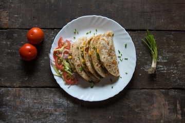 Tortilla with meat and vegetable wraps on a plate with use of selective focus