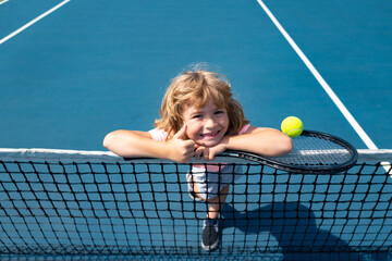 Little boy playing tennis. Sport kids, thumbs up, winner. Child with tennis racket on tennis court....