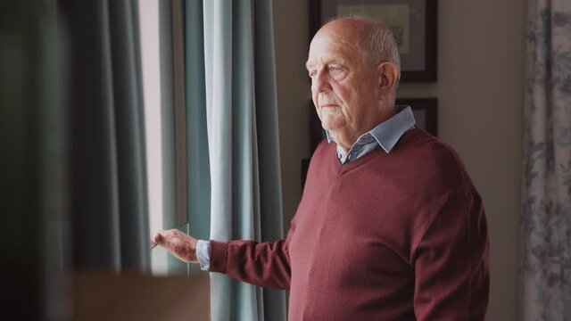Upset senior man near window