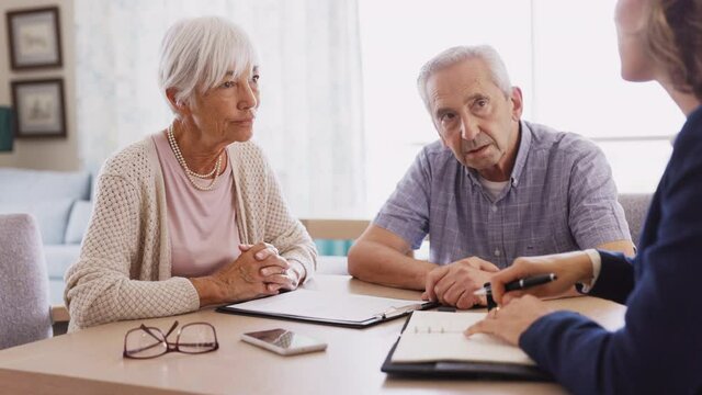 Senior couple planning their investments with financial advisor
