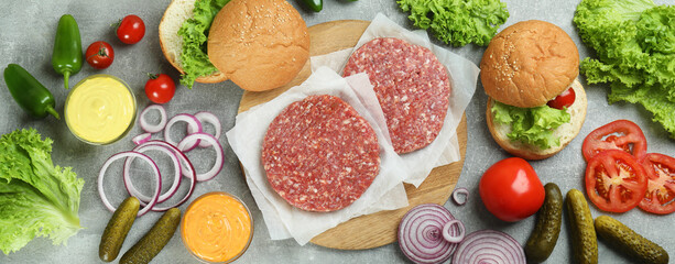 Concept of cooking burger on gray textured table