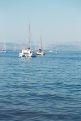 Fototapeta premium yachts in the bay and mountains in the background