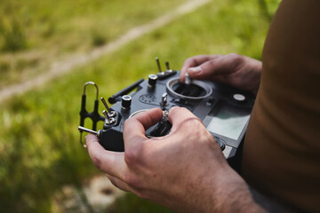 Man flying a high-speed racing drone with remote controller.  remote aerial quadcopter drone