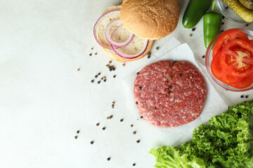 Concept of cooking burger on white textured background
