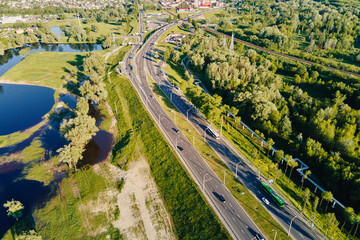 Car moving on the bridge road in the city. Cityscape aerial view. Urban landscape with highway road, bird eye view