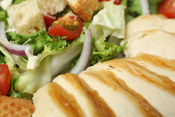 Tasty Caesar salad on whole background, close up