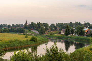 Landscape with a river in the evening. Panorama of the city of Suzdal - obrazy, fototapety, plakaty