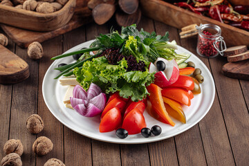 Fresh vegetables platter with greens on decorated background