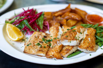 Roasted fish with vegetables on plate