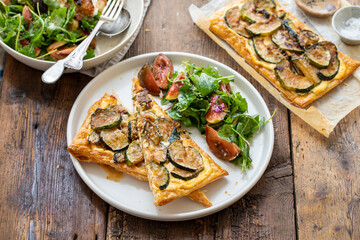 Puff pastry tart with caramelized courgettes and cheese with side of fig salad