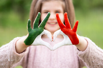 Child hands in heart shape painted in Mexico flag color, focus on hands. Love Mexico. Concept of...