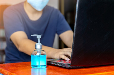 Young man working at home preventive virus corona.