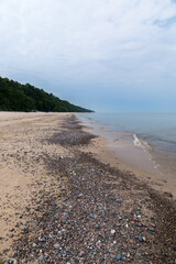 Baltic Sea coast in Poland, waves, sea foam, sky and beach