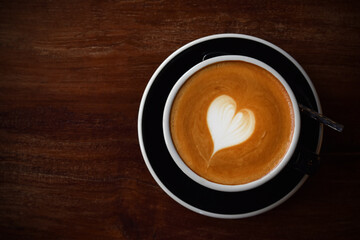 Top view wooden table, Warm coffee in the style of love with copy space.