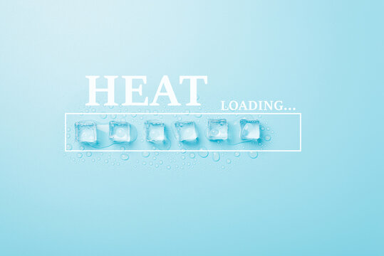 Hot summer weather is coming concept. Photo of melting ice cubes with drops and word heat loading on light blue color backdrop