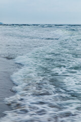 Naklejka na ściany i meble Baltic Sea coast in Poland, waves, sea foam, sky and beach
