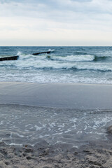 Baltic Sea coast in Poland, waves, sea foam, sky and beach