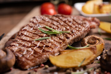 Sliced grilled medium rare beef steak served with fries