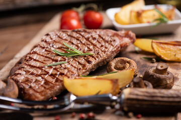 Sliced grilled medium rare beef steak served with fries