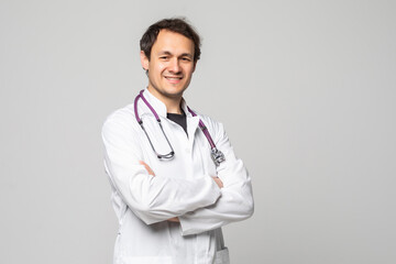 Smiling medical doctor with stethoscope over white background