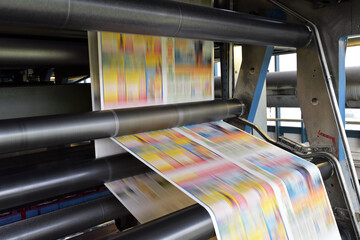 printing of coloured newspapers with an offset printing machine at a printing press company - 444919195