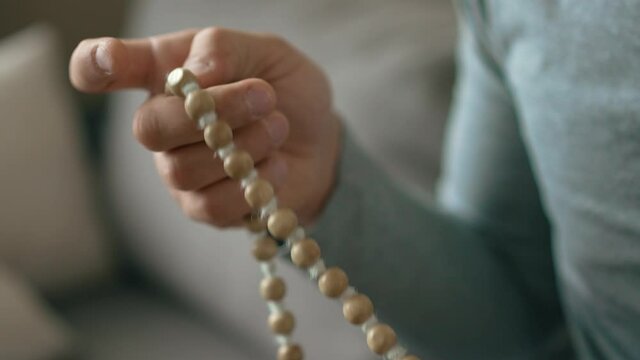 Beads in a hand of a man