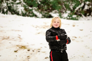 Young blonde boy playing in the snow at Mount Stirling, in the Victorian snow fields during the 2021 winter season