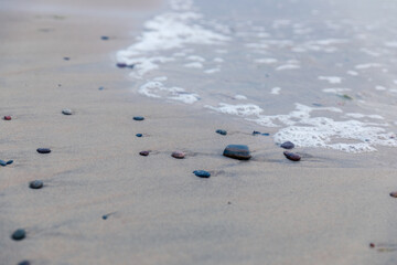 Baltic Sea coast in Poland, waves, sea foam, sky and beach