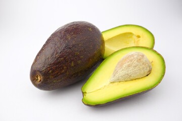 delicious fresh avocado halved isolated on white background
