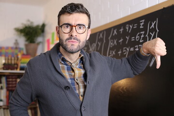 Disappointed teacher giving a thumbs down 