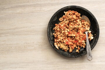 Selected Focus Sambal Tempeh, Spicy Crushed Tempe on Stone Pestle. Traditional Indonesian Food with Spicy and Savory Taste. Top View with Copy Space