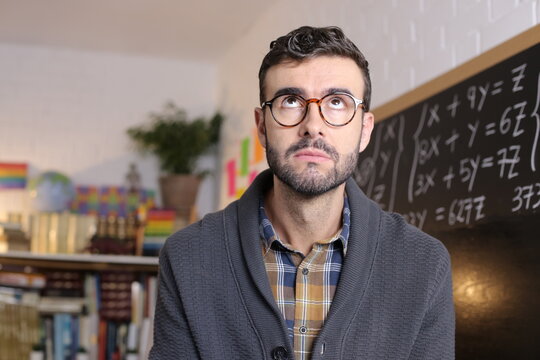 Frustrated teacher rolling eyes in classroom