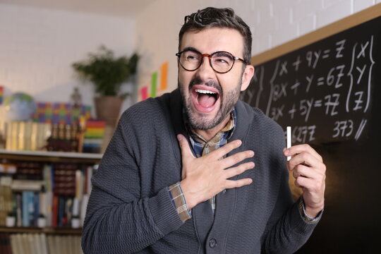 Teacher laughing out loud in classroom