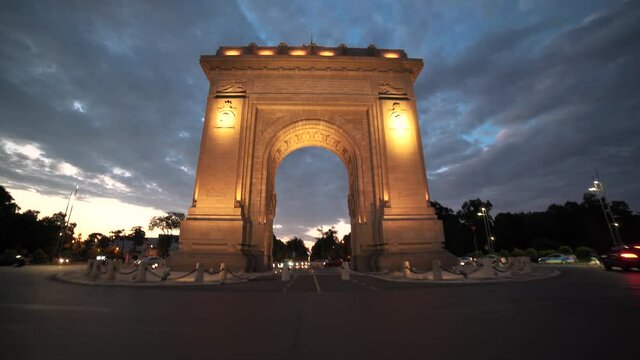 Moving shot of going through the Arch of Triumph Bucharest Square during corona virus pandemic, at dusk