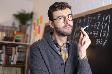 Anxious and stressed out teacher smoking in classrom