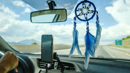 Dream catcher hanging insisde car on a backview mirror