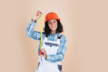 Enjoy the lifestyle. female foreman on construction site. carpenter assistant wear protective helmet. girl in workshop uniform. repairing tool used in engineering. architect working with tape measure