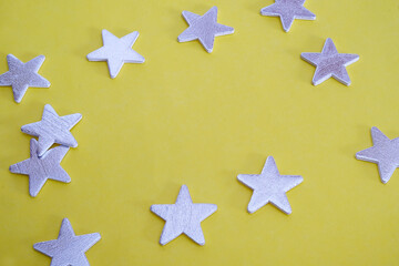 Fototapeta na wymiar Traditional christmas yellow background with silver stars for greeting lettering or announcement