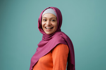 Middle eastern woman in hijab smiling and looking at camera