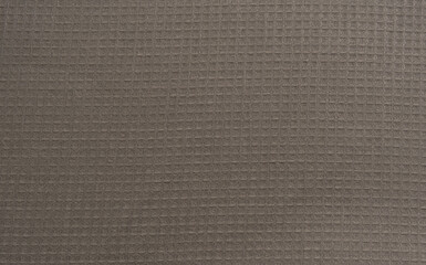Fototapeta premium Close up view of beige waffle fabric as background