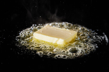 Butter frying on hot pan for cooking dish - obrazy, fototapety, plakaty