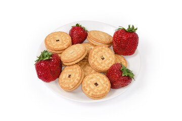 Sandwich cookies with strawberry jam filling among the fresh strawberries